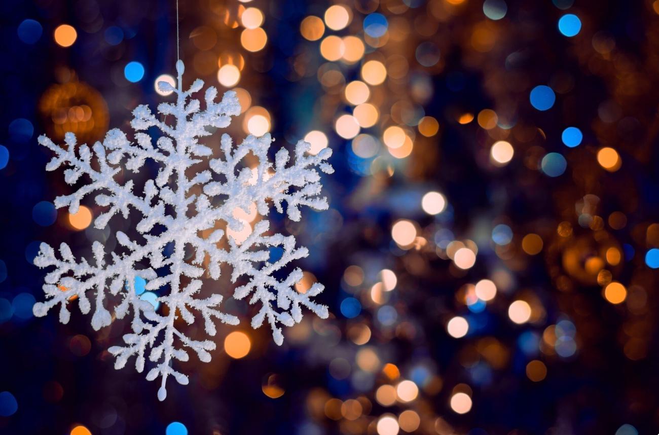 Snowflake with twinkling lights in the background